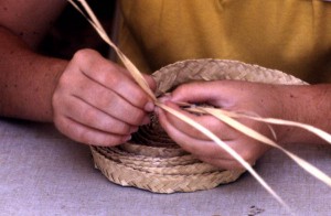 Pam Solano weaving palmetto leaves into textiles.