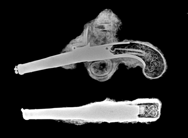Image 2. Pistol x-rays showing the shape of the hammer with intact flint, mainspring, and handle decorations.