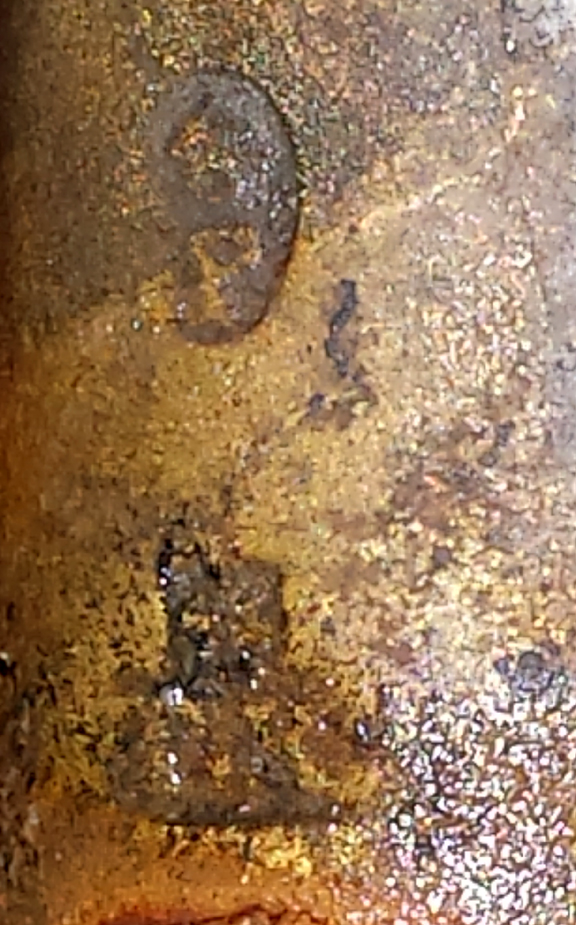 Proof marks found on the underneath side of the barrel. The top mark shows a crown with a P under it and is a true proof mark. The bottom is much harder to see and appears to be a symbol with TK under it.