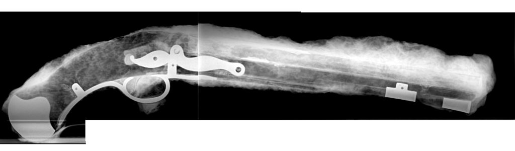Two x-rays stitched together showing entire pistol.
