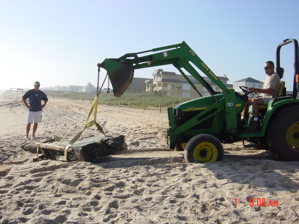 Excavating the rudder from the beach.
