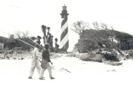people walking on beach in front of old St. Augustine Lighthouse